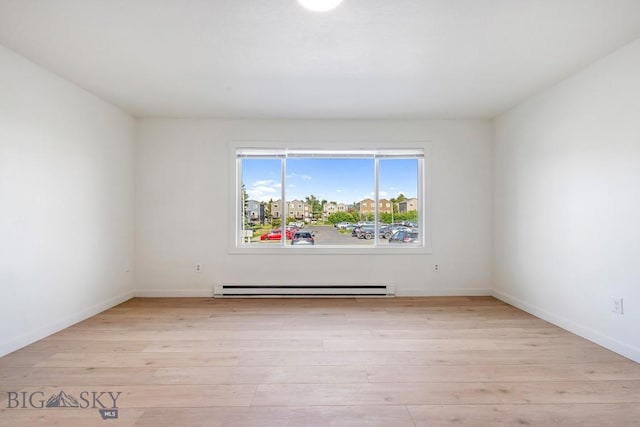1714 S 19th Ave, Bozeman, MT 59718 - spare room with a baseboard heating unit and light wood finished floors