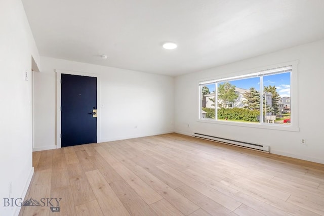 1714 S 19th Ave, Bozeman, MT 59718 - spare room with a baseboard heating unit and light wood finished floors
