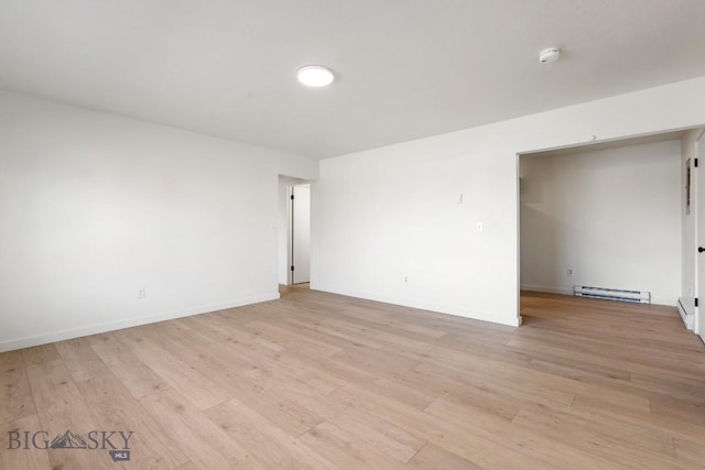 1714 S 19th Ave, Bozeman, MT 59718 - empty room with a smoke detector, light wood finished floors, and a baseboard radiator
