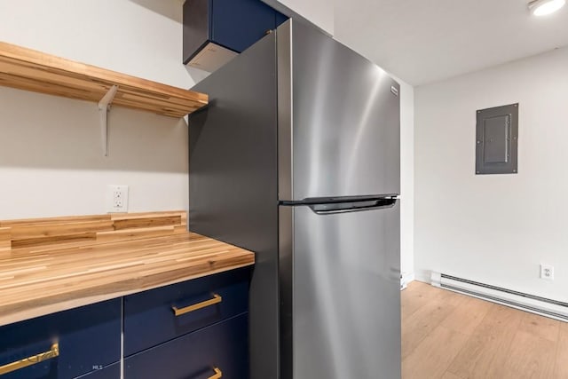 1714 S 19th Ave, Bozeman, MT 59718 - kitchen featuring freestanding refrigerator, blue cabinets, butcher block counters, electric panel, and light wood-type flooring