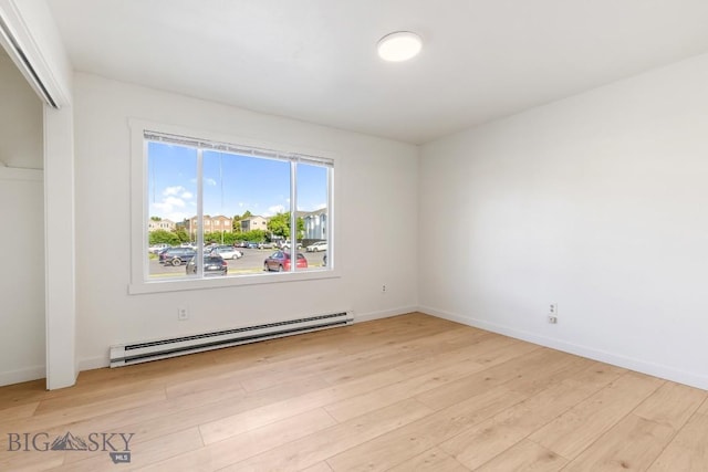 1714 S 19th Ave, Bozeman, MT 59718 - unfurnished bedroom featuring baseboard heating, wood finished floors, and a closet