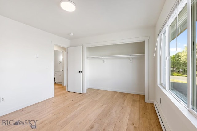 1714 S 19th Ave, Bozeman, MT 59718 - unfurnished bedroom with a closet, light wood finished floors, and a baseboard radiator