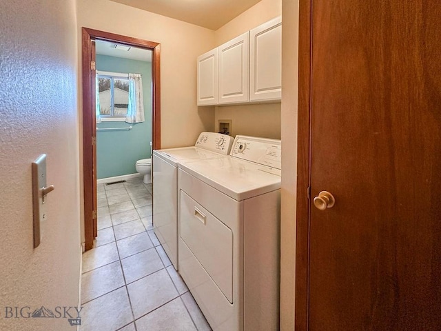 45 Chestnut Grove Ave, Bozeman, MT 59718 - laundry area featuring washer and dryer, light tile patterned floors, and cabinet space