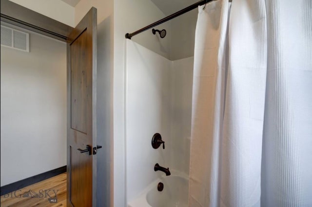 421 Otis Ave, Ennis, MT 59729 - bathroom featuring shower / bath combo and wood finished floors