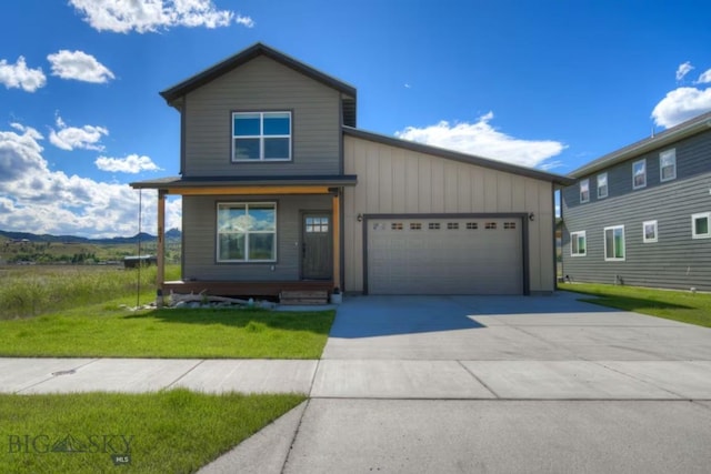 421 Otis Ave, Ennis, MT 59729 - view of front of home with an attached garage, driveway, a front lawn, and covered porch