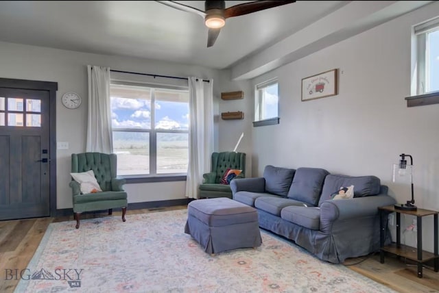 421 Otis Ave, Ennis, MT 59729 - living area featuring wood finished floors, healthy amount of natural light, and a ceiling fan