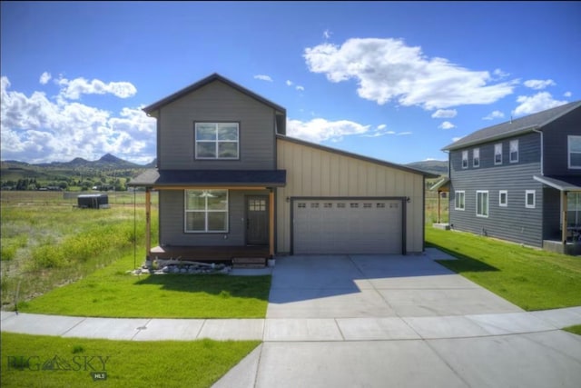421 Otis Ave, Ennis, MT 59729 - traditional-style house featuring a garage, concrete driveway, a front lawn, and a mountain view