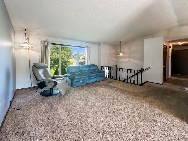 1716 S Rouse, Bozeman, MT 59715 - sitting room featuring an upstairs landing, carpet flooring, a textured ceiling, and vaulted ceiling