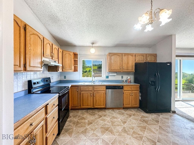 1716 S Rouse, Bozeman, MT 59715 - kitchen with black appliances, under cabinet range hood, a textured ceiling, plenty of natural light, and a chandelier