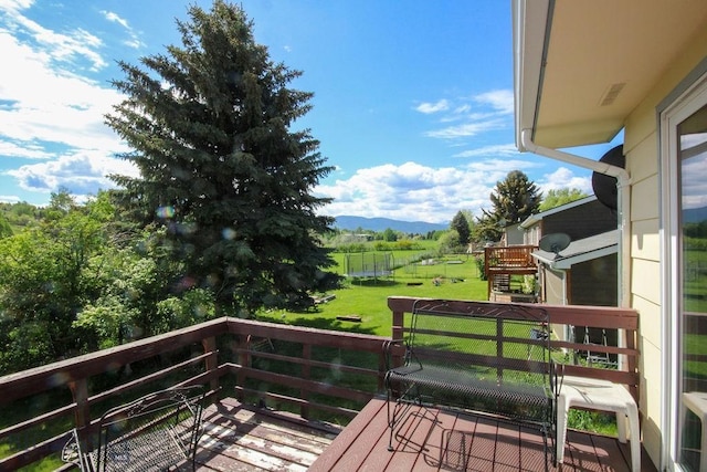 1716 S Rouse, Bozeman, MT 59715 - wooden deck featuring a yard, a mountain view, a playground, and a view of countryside