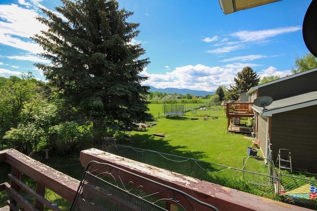1716 S Rouse, Bozeman, MT 59715 - view of yard featuring a trampoline, a rural view, and a deck with mountain view