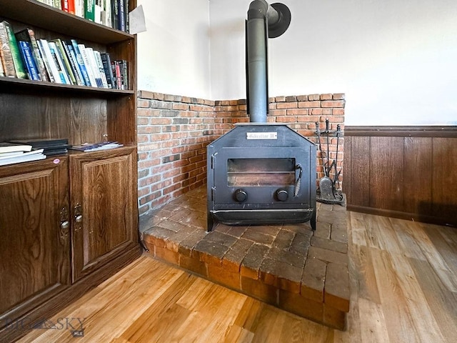 1716 S Rouse, Bozeman, MT 59715 - detailed view of a wood stove, wood finished floors, and wainscoting