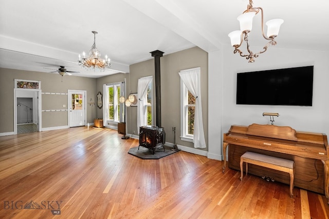 606 S Washington St, Dillon, MT 59725 - living room with a chandelier, a wood stove, light wood-type flooring, and ceiling fan