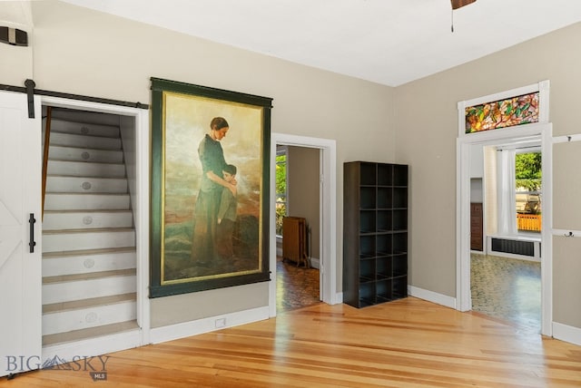 606 S Washington St, Dillon, MT 59725 - empty room featuring wood finished floors and a barn door