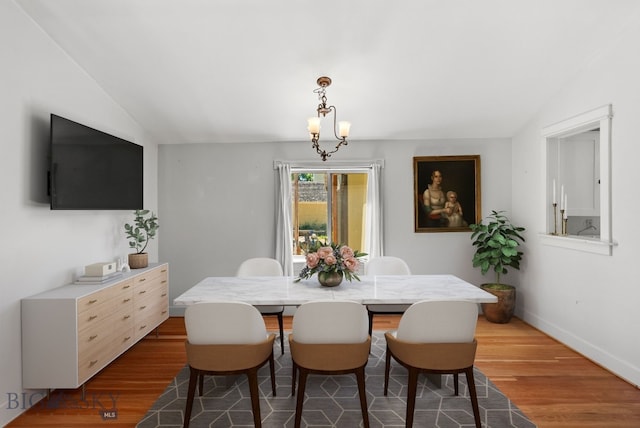606 S Washington St, Dillon, MT 59725 - dining room featuring wood finished floors, a chandelier, and lofted ceiling