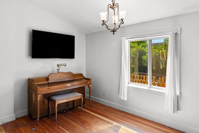 606 S Washington St, Dillon, MT 59725 - living area with wood finished floors, vaulted ceiling, and a chandelier