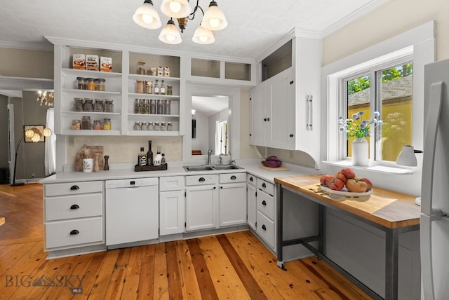 606 S Washington St, Dillon, MT 59725 - kitchen featuring dishwasher, a chandelier, ornamental molding, open shelves, and white cabinets