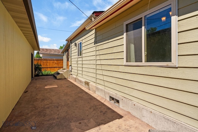 606 S Washington St, Dillon, MT 59725 - view of side of property featuring a patio