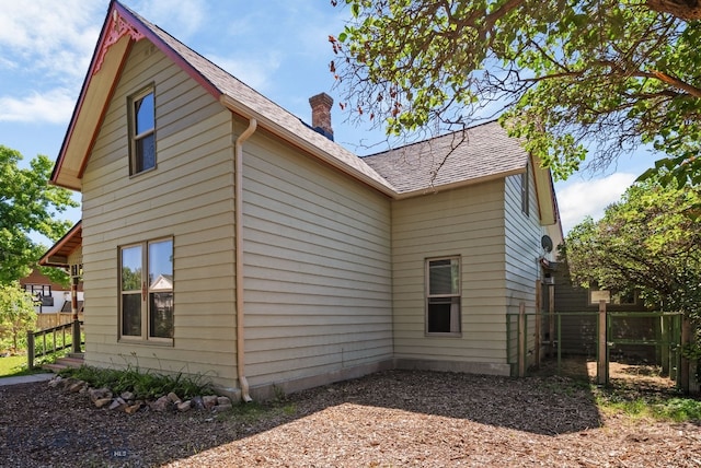 606 S Washington St, Dillon, MT 59725 - view of side of home with a chimney and a shingled roof