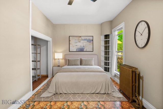 606 S Washington St, Dillon, MT 59725 - bedroom with radiator, wood finished floors, and a ceiling fan