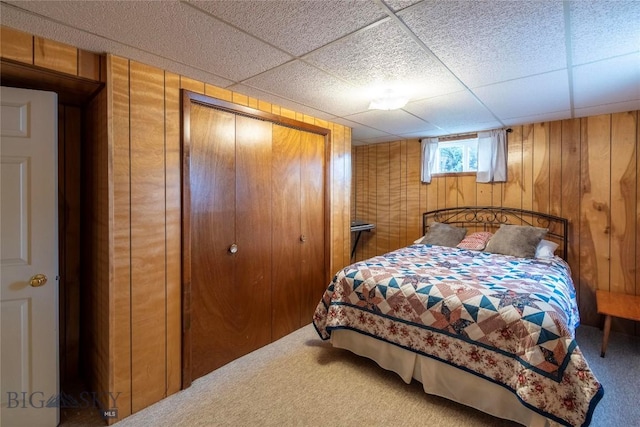 201 W 8th Ave, Big Timber, MT 59011 - bedroom with carpet, wooden walls, a closet, and a paneled ceiling