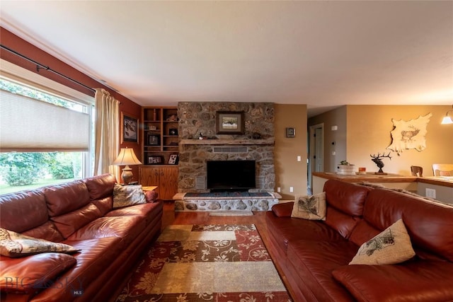 201 W 8th Ave, Big Timber, MT 59011 - living room featuring wood finished floors, a fireplace, and built in shelves