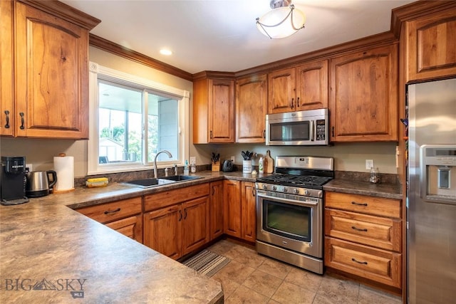201 W 8th Ave, Big Timber, MT 59011 - kitchen with stainless steel appliances, brown cabinets, dark countertops, and crown molding