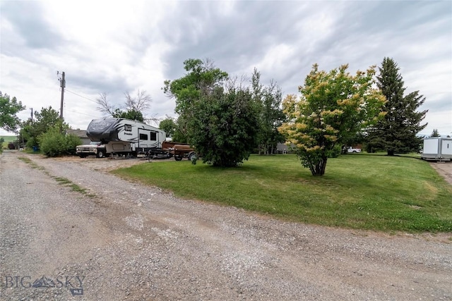 201 W 8th Ave, Big Timber, MT 59011 - view of property hidden behind natural elements featuring driveway and a front lawn