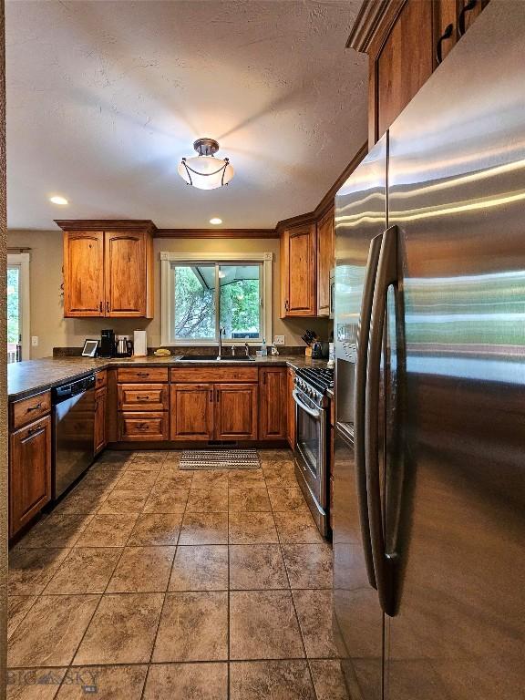 201 W 8th Ave, Big Timber, MT 59011 - kitchen featuring stainless steel appliances, dark countertops, and brown cabinetry