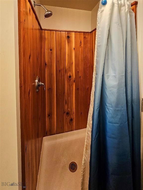 201 W 8th Ave, Big Timber, MT 59011 - full bathroom featuring a shower with shower curtain and wooden walls