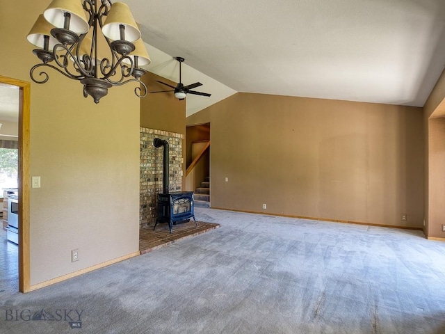 353 Sacajawea Peak Dr, Bozeman, MT 59718 - unfurnished living room featuring carpet floors, a wood stove, lofted ceiling, and a ceiling fan