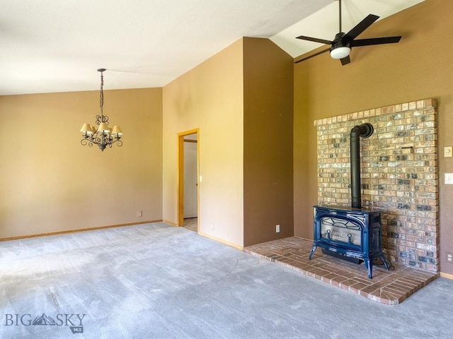 353 Sacajawea Peak Dr, Bozeman, MT 59718 - unfurnished living room with a ceiling fan, carpet flooring, a chandelier, a wood stove, and high vaulted ceiling