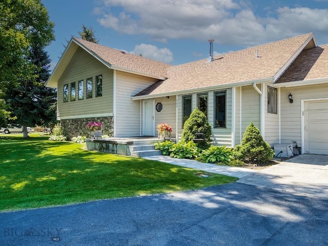 353 Sacajawea Peak Dr, Bozeman, MT 59718 - tri-level home featuring a front yard, roof with shingles, stone siding, and driveway