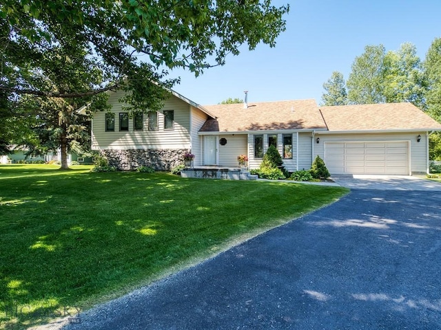 353 Sacajawea Peak Dr, Bozeman, MT 59718 - tri-level home featuring driveway, an attached garage, a front yard, and a shingled roof
