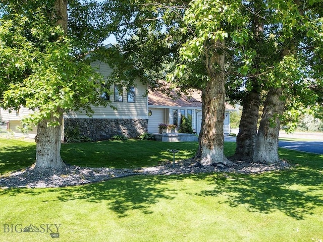 353 Sacajawea Peak Dr, Bozeman, MT 59718 - tri-level home with a front lawn and stone siding