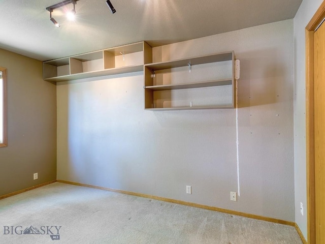 353 Sacajawea Peak Dr, Bozeman, MT 59718 - carpeted spare room with baseboards and rail lighting