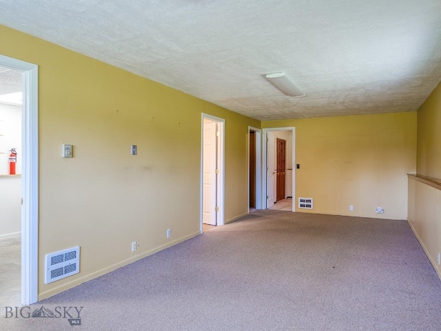 353 Sacajawea Peak Dr, Bozeman, MT 59718 - unfurnished room featuring light carpet and a textured ceiling