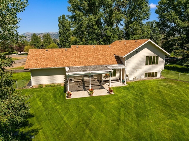 353 Sacajawea Peak Dr, Bozeman, MT 59718 - back of property with a pergola, a patio area, a fenced backyard, and a shingled roof