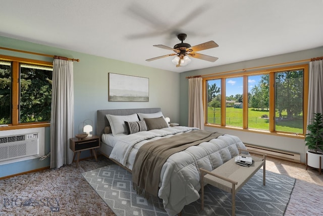 353 Sacajawea Peak Dr, Bozeman, MT 59718 - bedroom featuring baseboard heating, a ceiling fan, a wall unit AC, and carpet floors