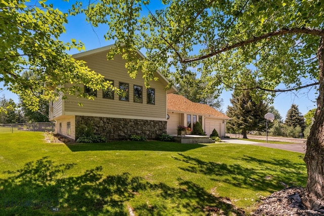 353 Sacajawea Peak Dr, Bozeman, MT 59718 - view of front of property featuring stone siding, concrete driveway, and a garage