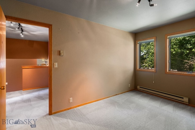 353 Sacajawea Peak Dr, Bozeman, MT 59718 - spare room with a baseboard heating unit, track lighting, and light carpet