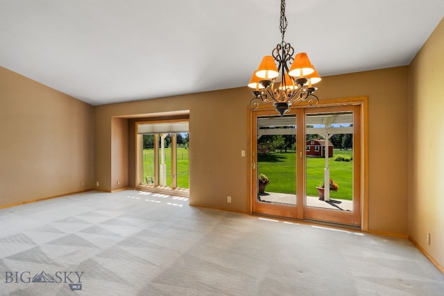 353 Sacajawea Peak Dr, Bozeman, MT 59718 - unfurnished room with a chandelier, plenty of natural light, and light carpet