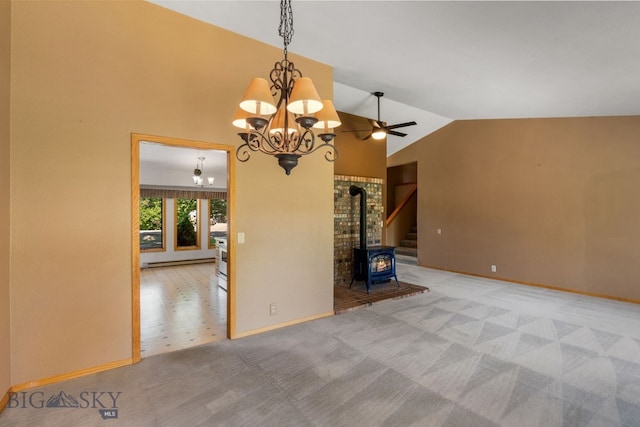 353 Sacajawea Peak Dr, Bozeman, MT 59718 - unfurnished living room featuring a chandelier, a wood stove, a baseboard radiator, lofted ceiling, and carpet flooring