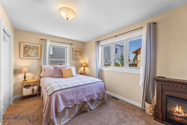 818 N 13th St, Livingston, MT 59047 - carpeted bedroom featuring baseboards and a glass covered fireplace
