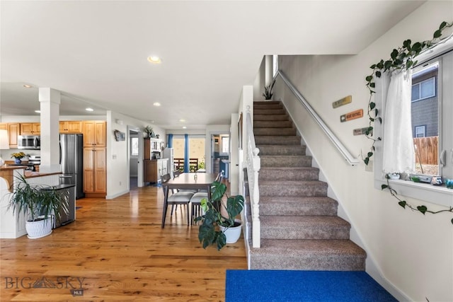 818 N 13th St, Livingston, MT 59047 - stairway with wood finished floors, recessed lighting, and ornate columns