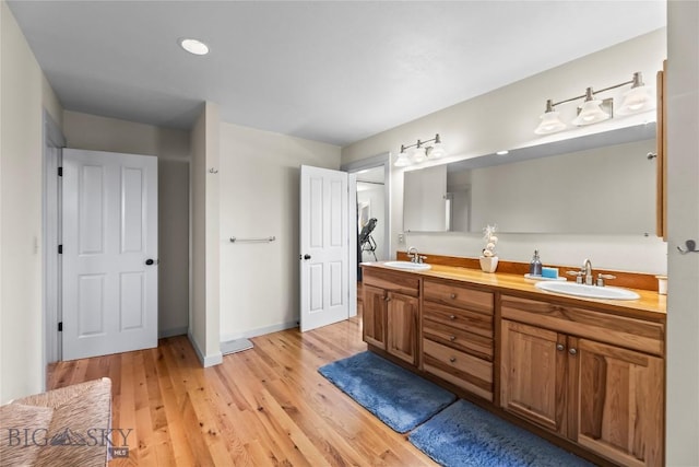 818 N 13th St, Livingston, MT 59047 - full bathroom featuring double vanity and wood finished floors
