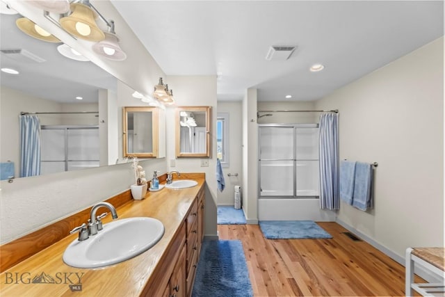 818 N 13th St, Livingston, MT 59047 - full bath with wood finished floors, double vanity, shower / tub combo, and recessed lighting