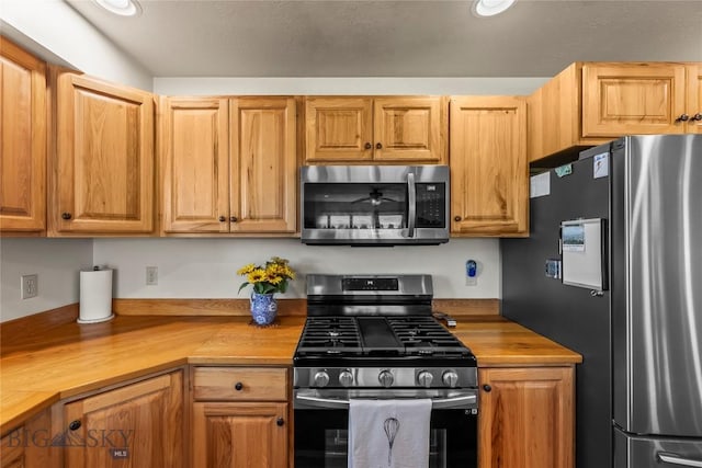 818 N 13th St, Livingston, MT 59047 - kitchen featuring stainless steel appliances, wood counters, and recessed lighting