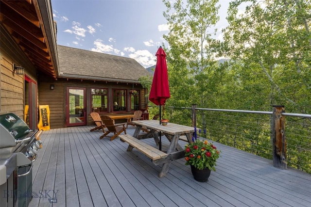 526 Chief Joseph, Big Sky, MT 59716 - wooden terrace featuring outdoor dining area and area for grilling