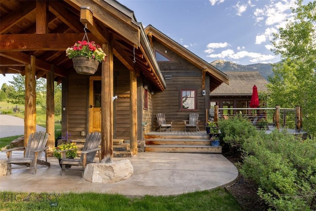 526 Chief Joseph, Big Sky, MT 59716 - property entrance with a deck with mountain view and a patio area